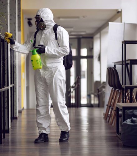 A man disinfecting tables - Turnkey Remediation