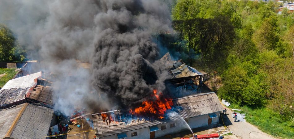 house on fire with big smoke with firefighters
